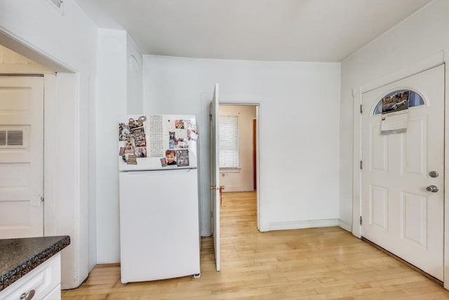 entryway featuring light wood-style flooring and visible vents
