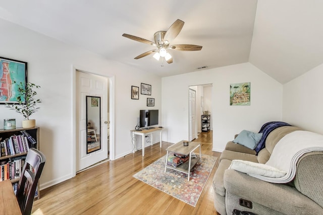 living area featuring vaulted ceiling, ceiling fan, visible vents, and light wood-style floors