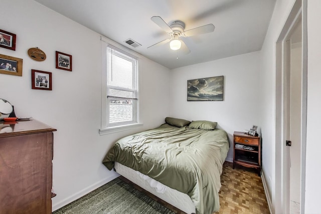 bedroom featuring baseboards, a ceiling fan, and visible vents