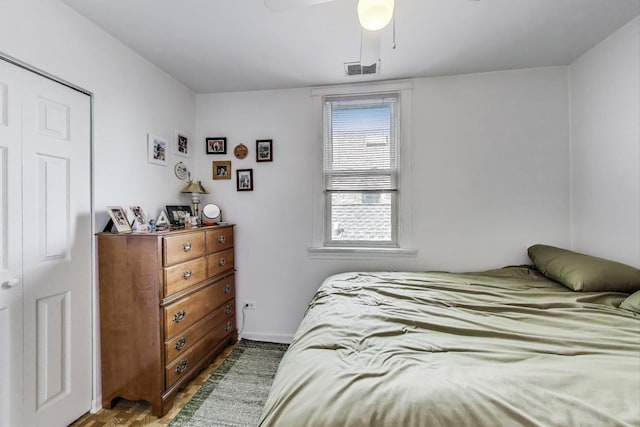bedroom with visible vents, baseboards, and ceiling fan