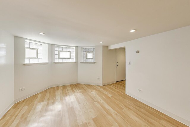 spare room with light wood-type flooring, baseboards, and recessed lighting