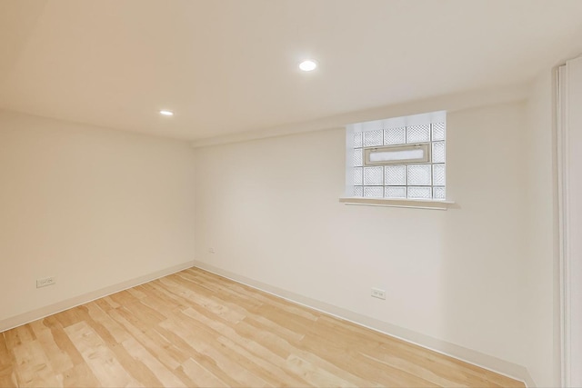 empty room with baseboards, recessed lighting, and wood finished floors