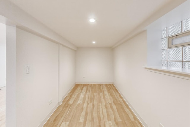 interior space with baseboards, recessed lighting, and wood finished floors