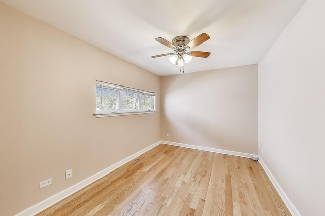 spare room with a ceiling fan, baseboards, and light wood finished floors