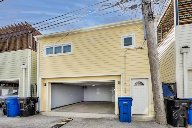back of house featuring a garage