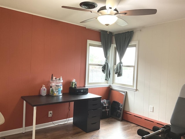office featuring ceiling fan, a baseboard heating unit, and wood finished floors