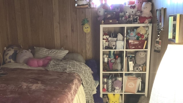 bedroom with wood walls