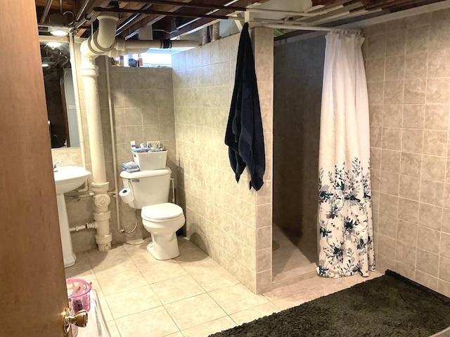 bathroom with toilet, tile patterned floors, tile walls, and a shower stall