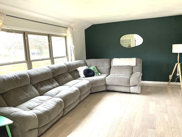 living room featuring vaulted ceiling and wood finished floors