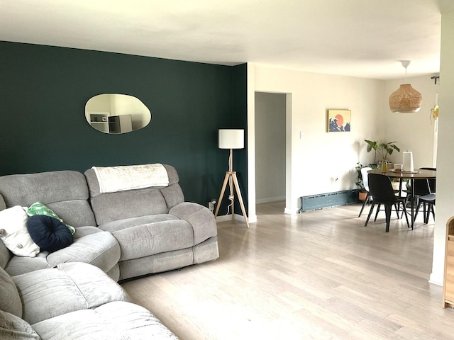 living room with baseboards and light wood-style flooring