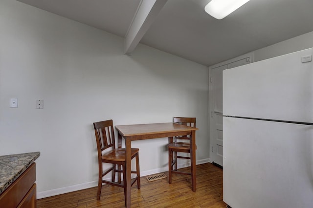 66W Jeffery Ave, Wheeling, IL 60090 - dining space featuring vaulted ceiling with beams, baseboards, and wood finished floors