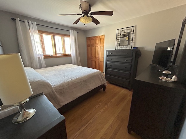 bedroom featuring wood finished floors, a closet, and ceiling fan