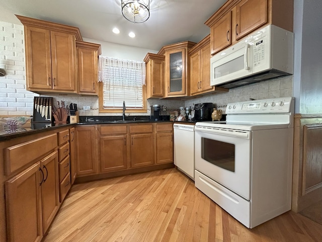 kitchen with white appliances, brown cabinets, and recessed lighting