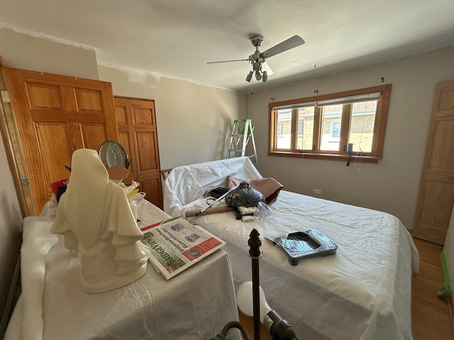 bedroom featuring wood finished floors and ceiling fan
