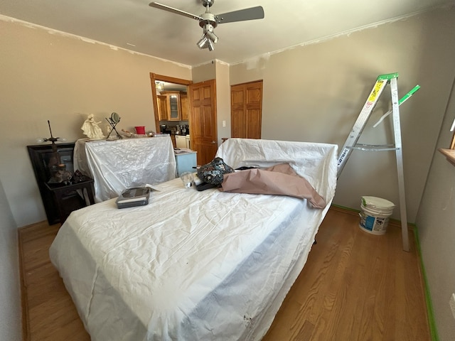 bedroom with wood finished floors, a closet, and ceiling fan
