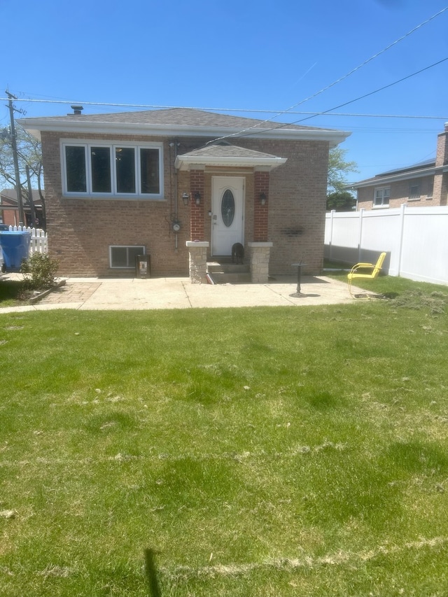 view of front of house featuring brick siding and a patio