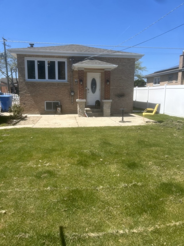 view of front of property with brick siding, a patio area, central AC unit, and roof with shingles