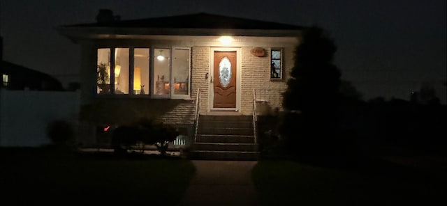 view of exterior entry at night