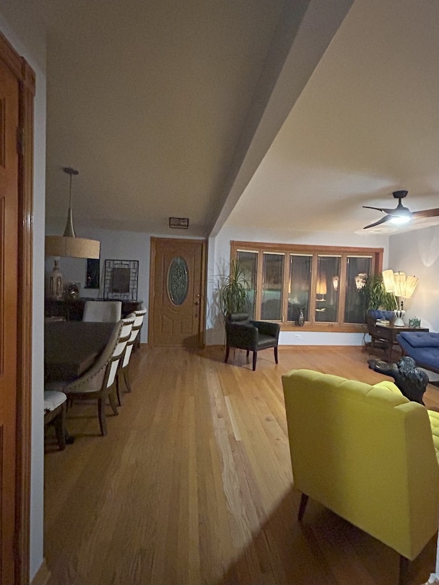 living area with wood finished floors and ceiling fan