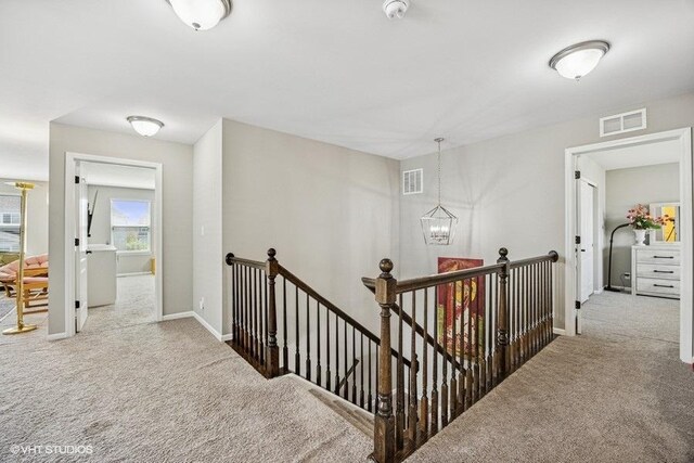 1683 Rockefeller Dr, Mundelein, IL 60060 - corridor with an upstairs landing, carpet, a chandelier, and baseboards