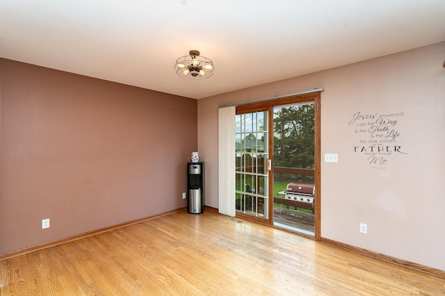 1918 Clement St, Crest Hill, IL 60403 - empty room with light wood-type flooring, baseboards, water heater, and a notable chandelier