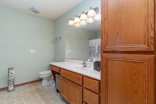 1918 Clement St, Crest Hill, IL 60403 - bathroom featuring vanity, baseboards, toilet, and visible vents