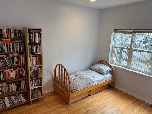bedroom featuring baseboards and wood finished floors