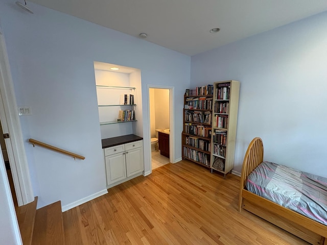 living area featuring light wood-type flooring and baseboards