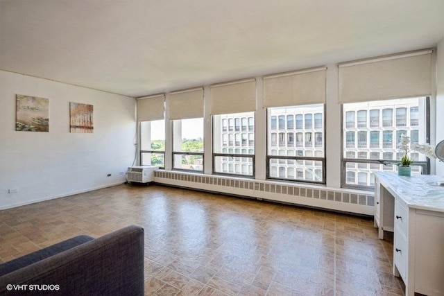 interior space with radiator and baseboards