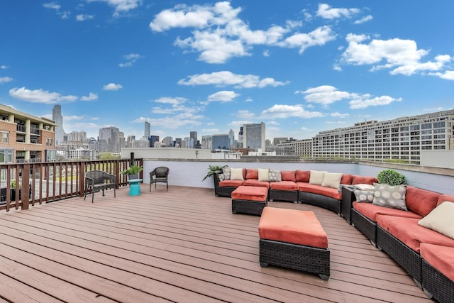 wooden deck featuring outdoor lounge area and a view of city