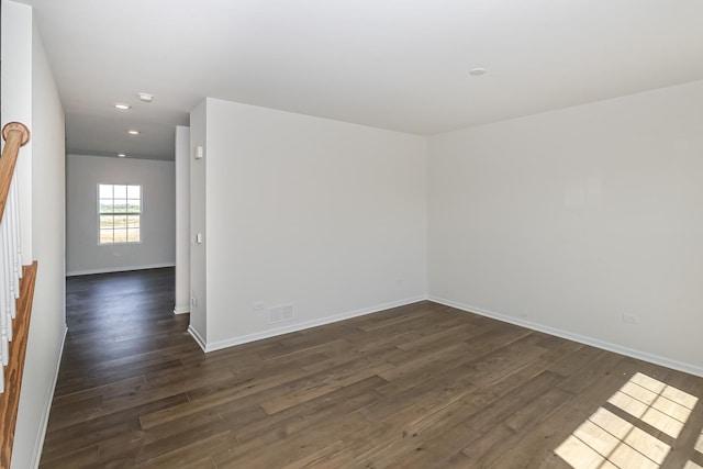 empty room featuring recessed lighting, baseboards, visible vents, and dark wood-style floors