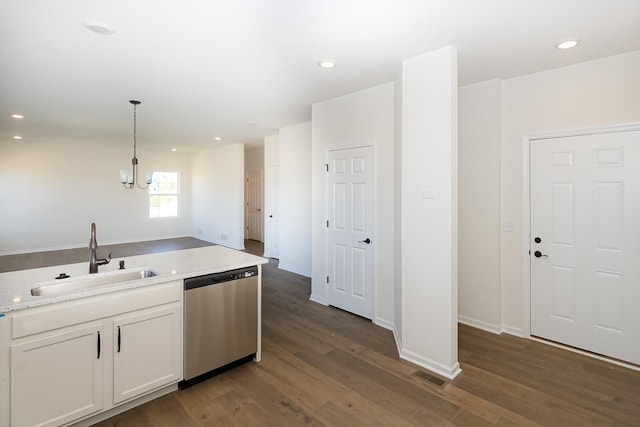 kitchen featuring visible vents, wood finished floors, white cabinets, a sink, and dishwasher