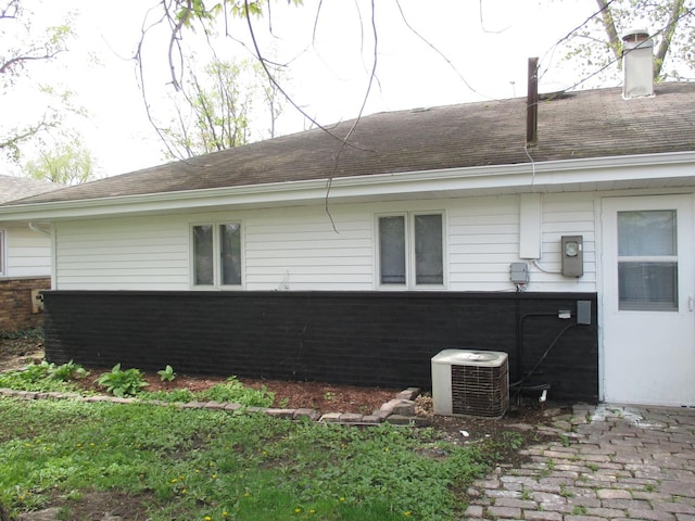 439 Indianwood Blvd, Park Forest, IL 60466 - view of property exterior featuring central AC unit, a shingled roof, and brick siding