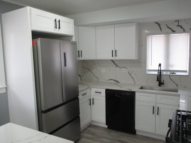 439 Indianwood Blvd, Park Forest, IL 60466 - kitchen featuring freestanding refrigerator, black dishwasher, a sink, and white cabinetry