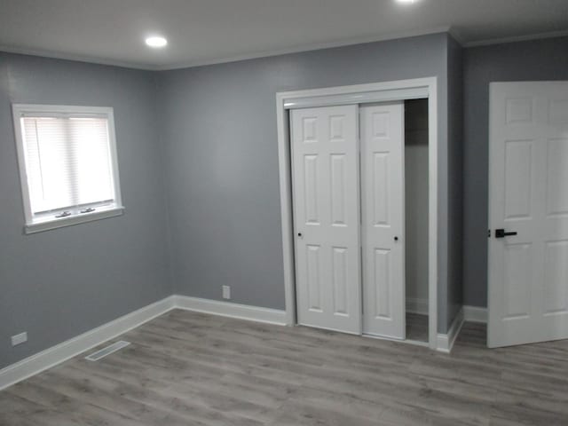 439 Indianwood Blvd, Park Forest, IL 60466 - unfurnished bedroom featuring a closet, crown molding, baseboards, wood finished floors, and recessed lighting