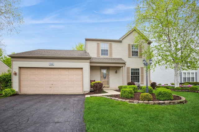 1326 Narragansett Dr, Carol Stream, IL 60188 - traditional-style house featuring asphalt driveway, a front lawn, and a garage