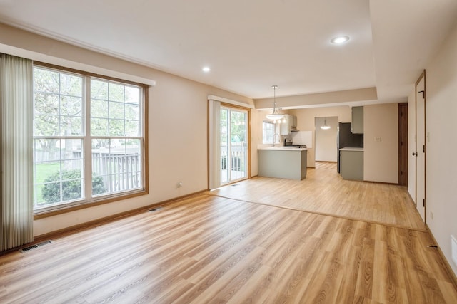 1326 Narragansett Dr, Carol Stream, IL 60188 - unfurnished living room with light wood finished floors, baseboards, and recessed lighting