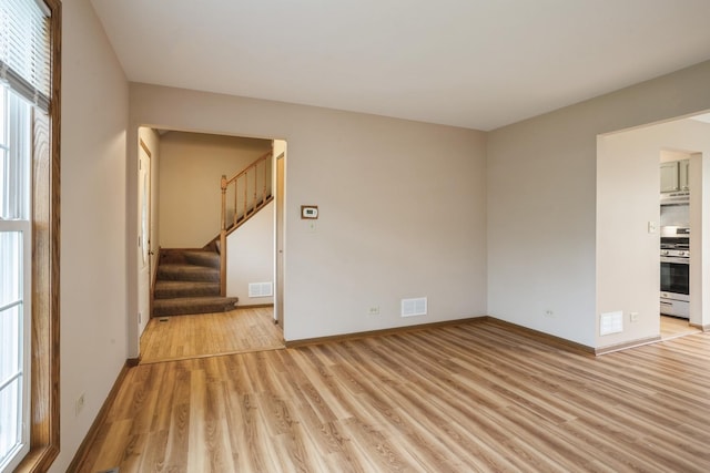 1326 Narragansett Dr, Carol Stream, IL 60188 - unfurnished living room featuring light wood-style flooring, stairs, and baseboards