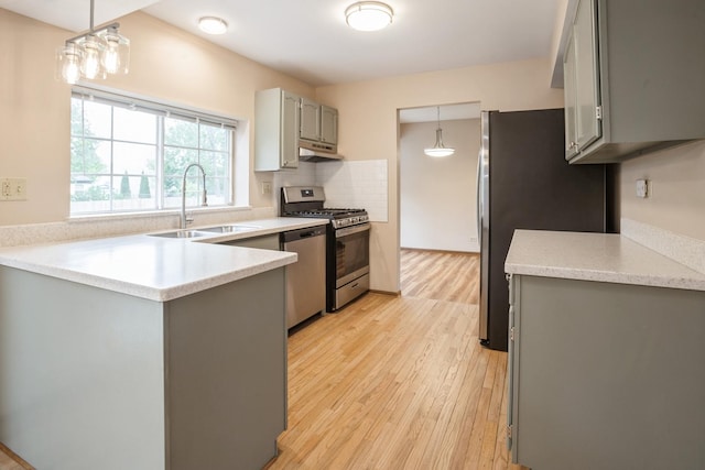 1326 Narragansett Dr, Carol Stream, IL 60188 - kitchen with gray cabinets, a sink, stainless steel appliances, under cabinet range hood, and light wood-style flooring