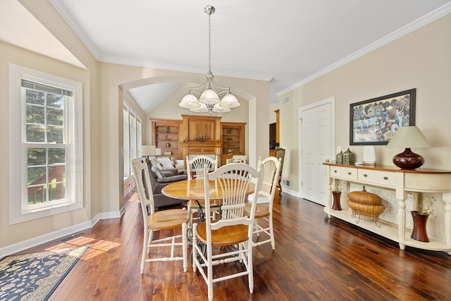 610 Wind Energy Pass, Batavia, IL 60510 - dining space featuring a chandelier, dark wood finished floors, arched walkways, baseboards, and ornamental molding