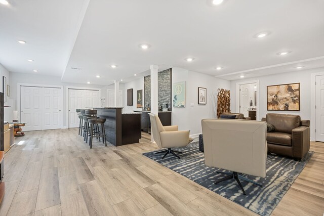 610 Wind Energy Pass, Batavia, IL 60510 - living area featuring light wood-type flooring, ornate columns, bar area, and recessed lighting