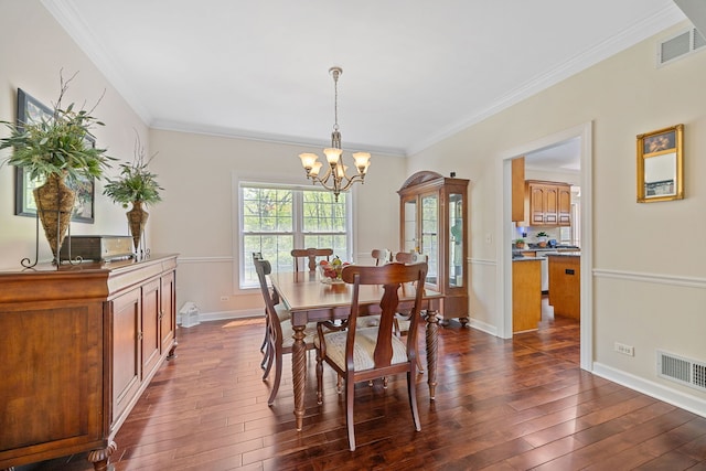 610 Wind Energy Pass, Batavia, IL 60510 - dining space with a chandelier, crown molding, dark wood-style flooring, and baseboards