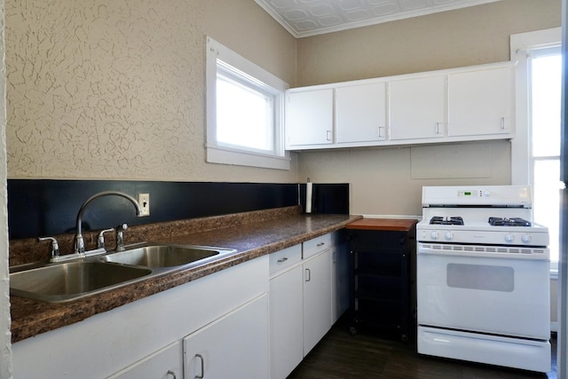 221 N Main St, Wilmington, IL 60481 - kitchen with white cabinetry, plenty of natural light, a sink, and white range with gas cooktop
