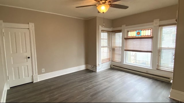 221 N Main St, Wilmington, IL 60481 - unfurnished room with dark wood-style flooring, crown molding, a ceiling fan, baseboard heating, and baseboards