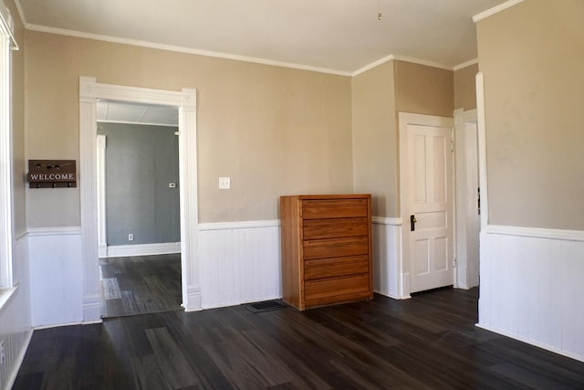 221 N Main St, Wilmington, IL 60481 - empty room featuring wainscoting, ornamental molding, and dark wood finished floors