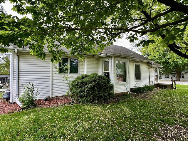 view of side of property with a lawn