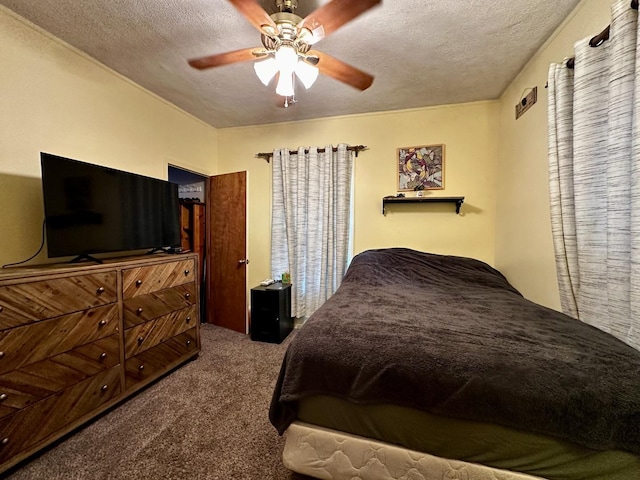 bedroom with ceiling fan, carpet flooring, and a textured ceiling