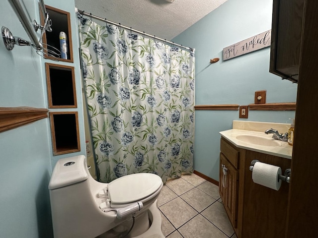 bathroom featuring vanity, toilet, a shower with shower curtain, a textured ceiling, and tile patterned floors