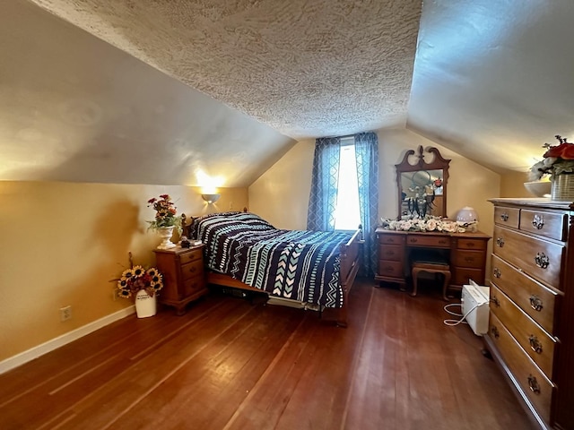bedroom with a textured ceiling, baseboards, lofted ceiling, and dark wood-type flooring