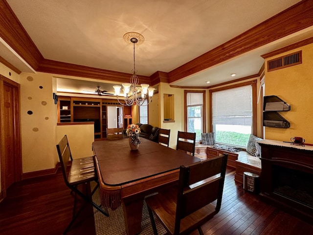 dining room featuring visible vents, dark wood finished floors, crown molding, and a notable chandelier